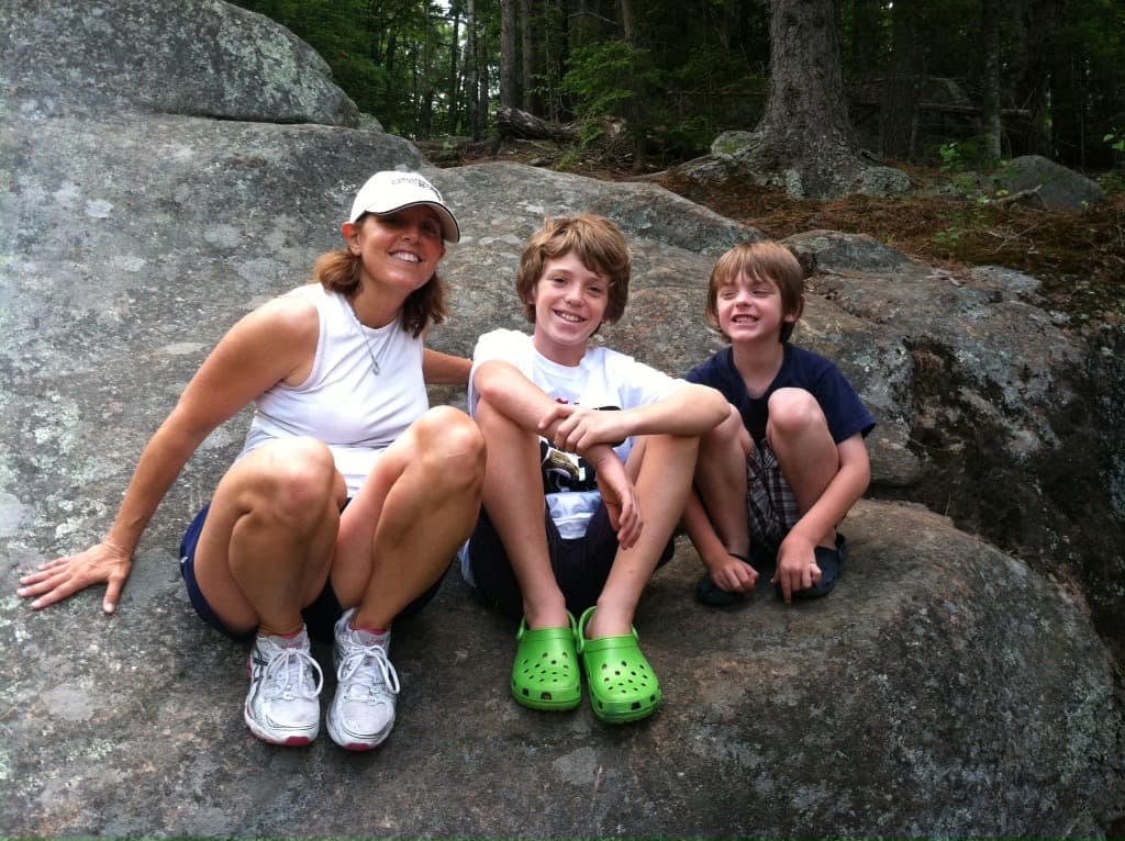 Debbie with kids on the rocks